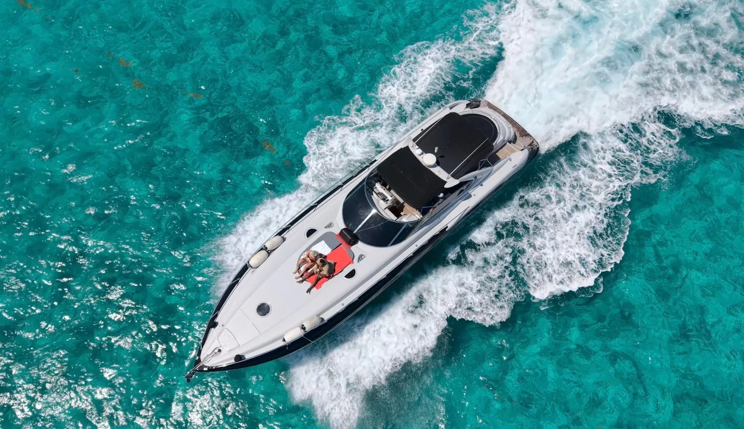A yacht cruising through turquoise water